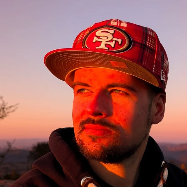 Timo Prüße outdoors at sunset, looking aside